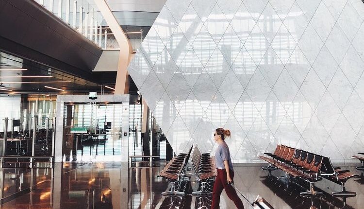 A person hold bag and walking at air port